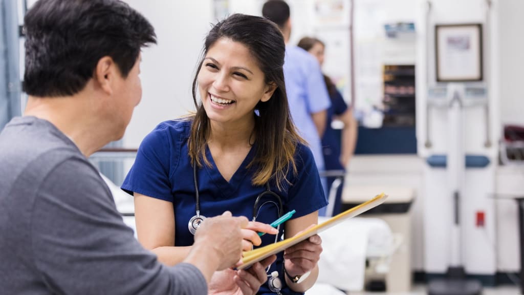 Caring nurse helps patient with medical document